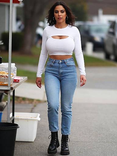 Voluptuous Woman in Light Wash High-Waisted Jeans and White Crop Top Streetwear