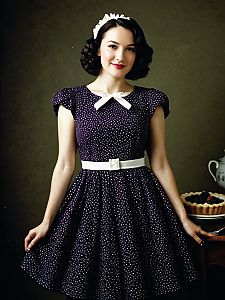 Retro Woman in 1950s Polka Dot Dress with Dessert Background