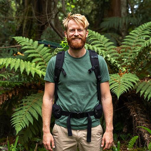 Smiling Man Hiking in Green Forest with Backpack