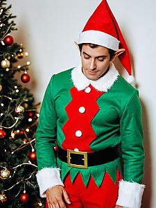 Man in Elf on the Shelf Costume with Christmas Tree Background
