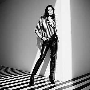 Confident Woman in Striped Jacket and Leather Pants