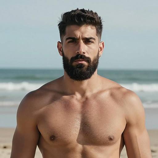 Bearded Muscular Man Standing Shirtless on the Beach