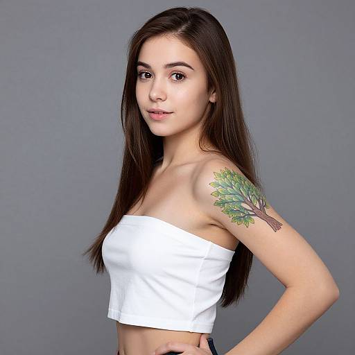 Young Woman with Tree Tattoo on Upper Arm in White Strapless Top