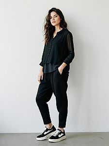 Woman in Contemporary Casual Layered Black Sheer Blouse and Black Pants