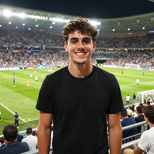 Smiling Young Man at Soccer Stadium During Match