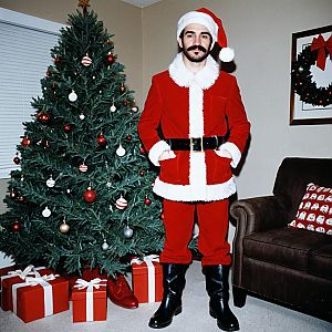 Santa Claus in Cozy Living Room with Christmas Tree