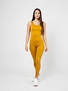 Woman in Mustard Yellow Athletic Leisure Unitard with Scoop Neckline and Side Lace-Up