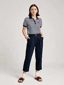 Woman in Casual Preppy Striped Polo Shirt Navy Blue and White with Navy Trousers