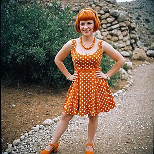 Woman in Orange Polka Dot Dress on Gravel Path