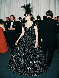 Elegant Woman in Vintage Polka Dot Gala Outfit with Feather Headpiece