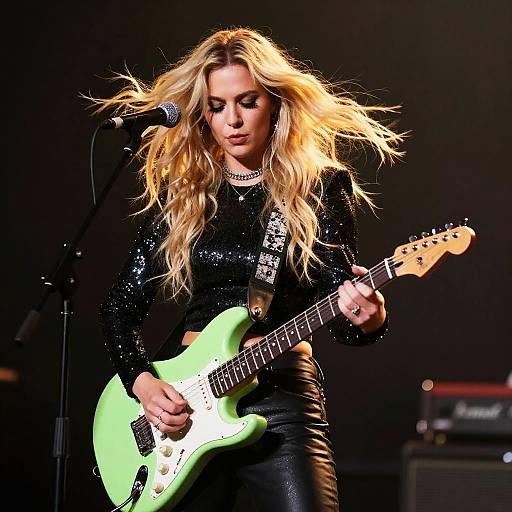 Blonde Woman Playing Light Green Electric Guitar on Stage
