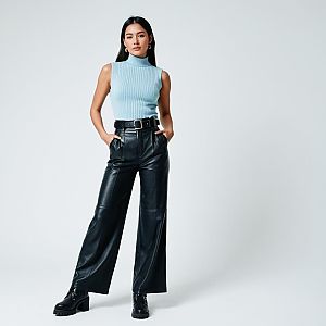 Confident Woman in Chic Blue Top and Black Leather Pants