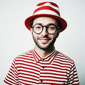 Man Wearing Classic Waldo Costume with Striped Shirt and Hat