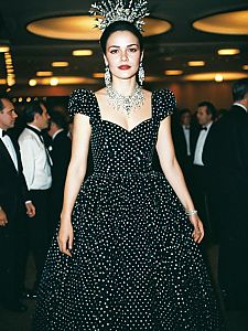 Elegant Woman in Vintage Black Polka Dot Gala Outfit with Statement Jewelry