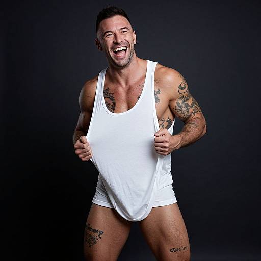 Energetic Muscular Man Laughing in White Tank Top with Tattoos