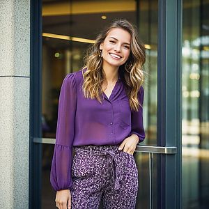 Confident Young Woman in Stylish Outfit at Modern Office