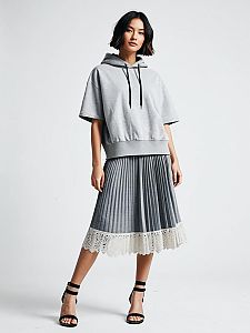 Fashionable Woman in Grey Hoodie and Pleated Skirt with Lace Trim
