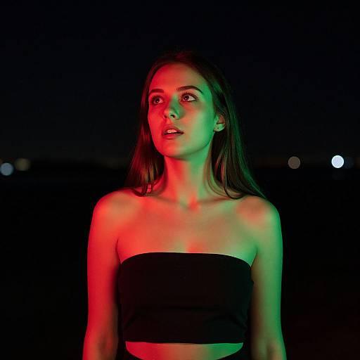 Young Woman in Dramatic Red and Green Night Lighting