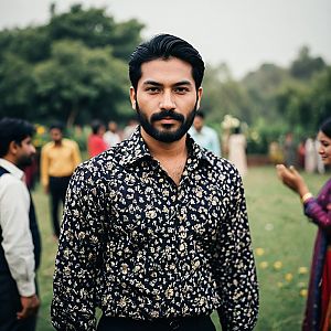 Man in Dark Floral Print Shirt in Garden