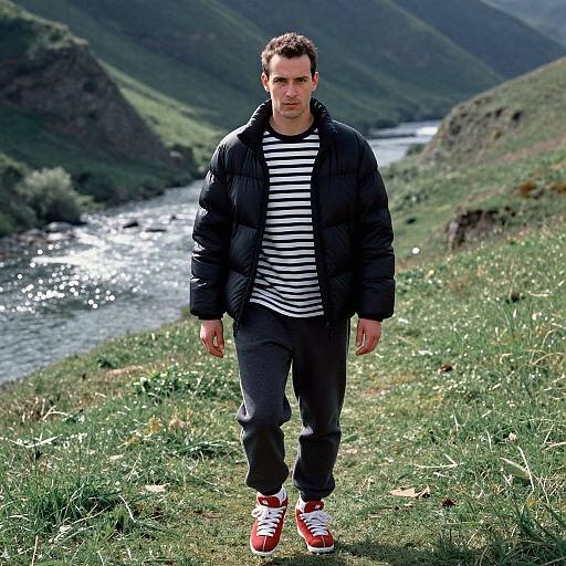 Man Walking Outdoors in Casual Jacket and Sneakers by River