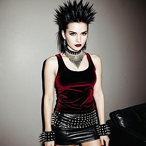 Punk Woman with Spiked Accessories and Bold Makeup in Velvet Top