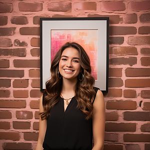 Smiling Young Woman with Wavy Hair in Front of Abstract Art and Brick Wall