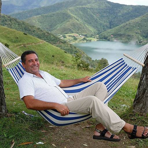 Man Relaxing on Striped Hammock with Mountain Lake View