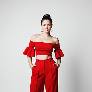 Confident Young Woman in Red Crop Top and High-Waisted Pants