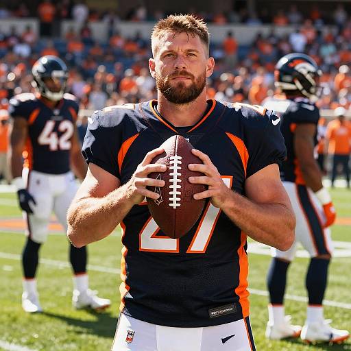 Denver Broncos Football Player Holding Football on Field