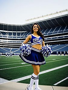 Cheerleader in Blue and White Outfit on Football Field