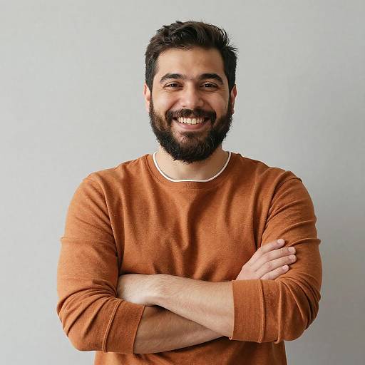 Smiling Bearded Man with Arms Crossed in Brown Sweater