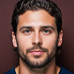 Close-up portrait of a young man with blue eyes and dark hair