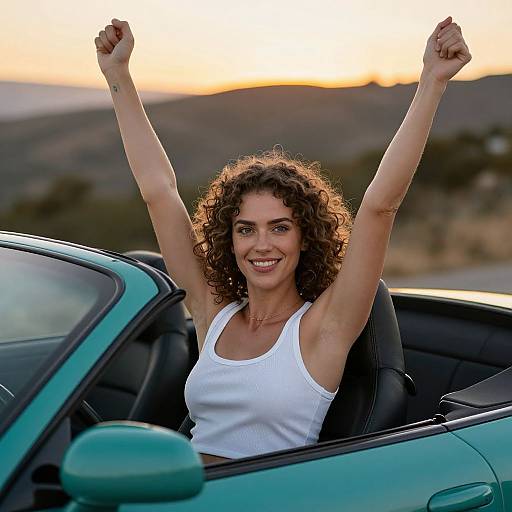 Happy Woman Celebrating in Convertible Car at Sunset