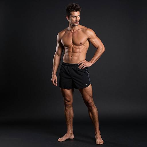 Muscular Fit Man in Black Athletic Shorts Standing Barefoot Studio
