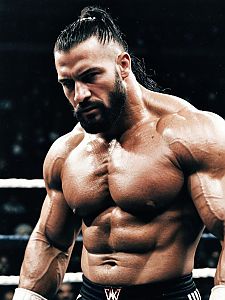 Muscular Male WWE Fighter with Man Bun in Wrestling Ring