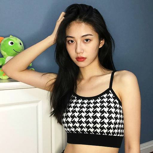 Confident Young Woman Wearing Houndstooth Crop Top Posing Indoors