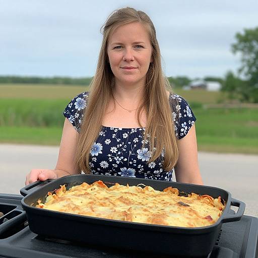 Woman Holding Freshly Baked Lasagna in Outdoor Setting